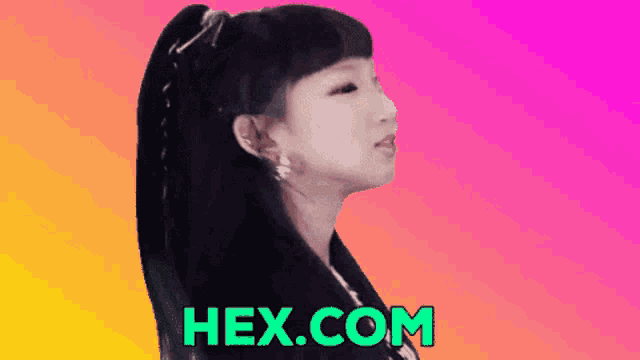 a girl with a ponytail stands in front of a hex.com ad