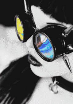 a woman wearing a choker and goggles with a rainbow lens