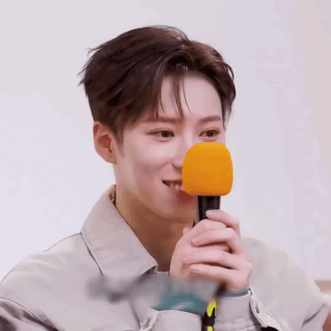 a close up of a person holding a microphone in front of their face