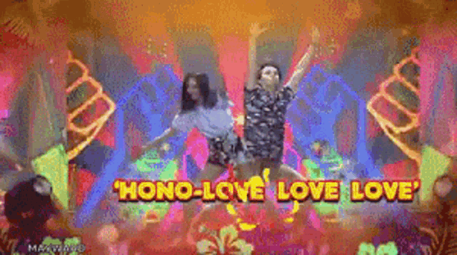 a couple of people are dancing on a stage with the words " hono-love love love "