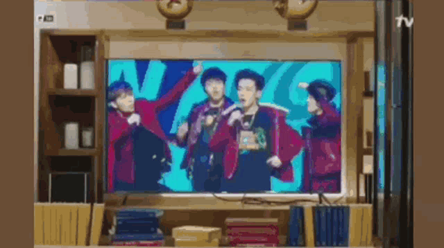 a group of people are dancing on a television screen .