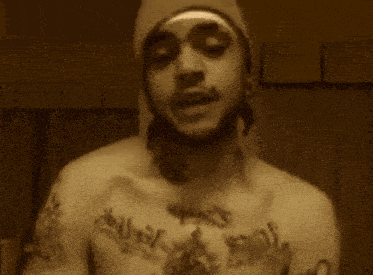 a man with a tattoo on his chest that says ' jesus '
