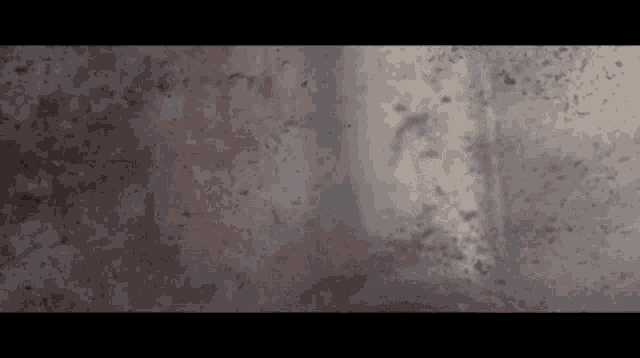 a close up of a wall with a few spots of dirt on it