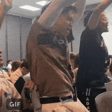 a group of people are dancing in a room and the word gif is on the bottom