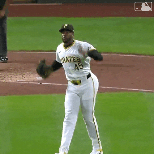 a baseball player with the number 45 on his jersey stands on the field