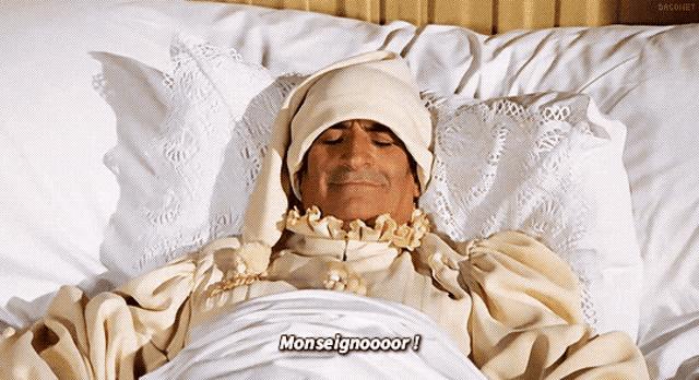 a man is laying in a bed with the word monseigneur written on the bottom