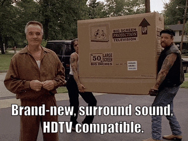 three men are carrying a box that says big screen projection television on it
