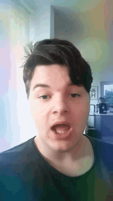 a young man is making a funny face with his mouth wide open