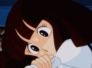a close up of a girl 's face with a hand on her face