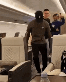 a group of people are standing on a plane .