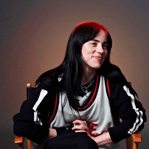 a woman wearing a black and white jersey with the letter f on it