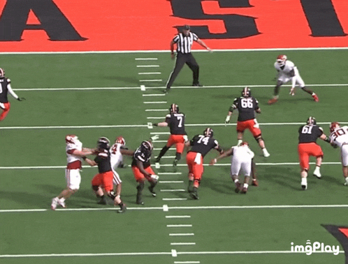 a group of football players on a field with a referee in the background and the word imgplay on the bottom right