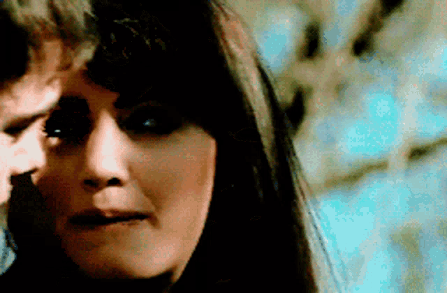 a close up of a woman 's face in a blurry photo
