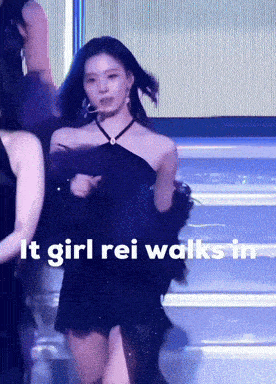 a woman in a black dress with the words " it girl rei walks in " on the bottom