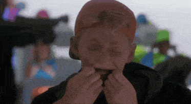 a man wearing a red hat and goggles holds his mouth open
