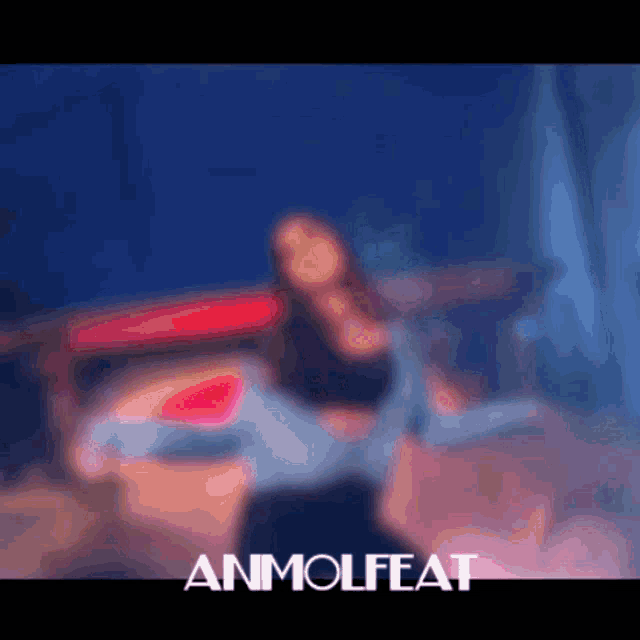 a blurry picture of a person with the word anmolfeat on the bottom right