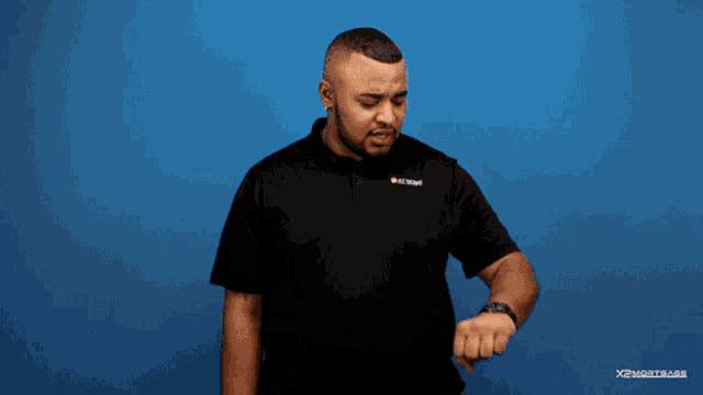 a man stands in front of a blue wall with the words where are yo written on it