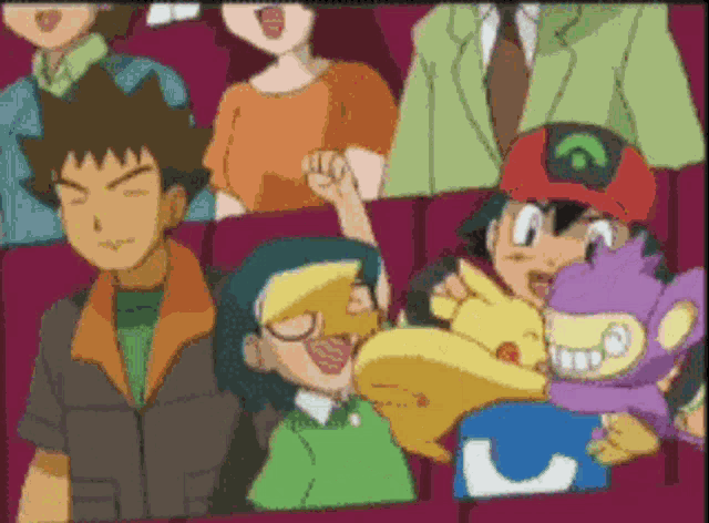 a group of people are sitting in a theater watching a cartoon
