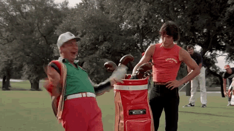 two men standing on a golf course with one wearing a shirt that says ' simpson '