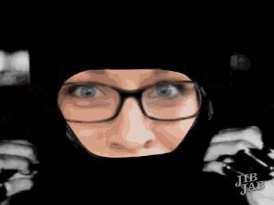 a close up of a woman wearing glasses and a mask with jib jab written on the bottom