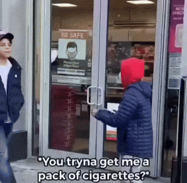 a person standing in front of a store with a sign on the door that says be safe