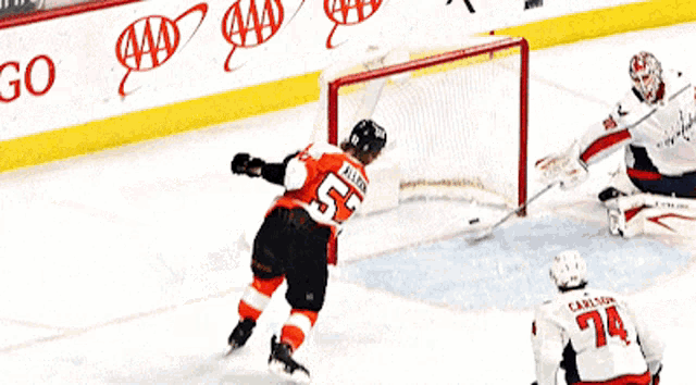 a hockey player with the number 24 on his jersey is holding a hockey stick