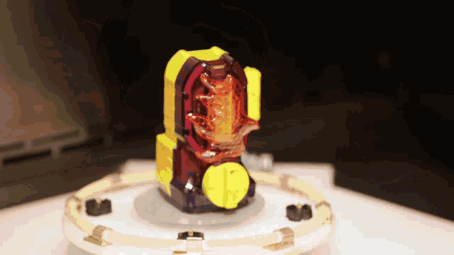 a purple and yellow toy with a yellow circle around it on a table