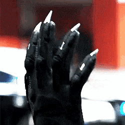 a close up of a person 's hand with long nails