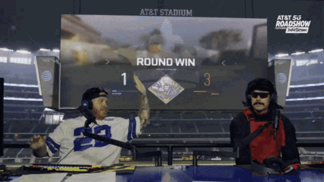 a man giving a high five in front of at & t stadium
