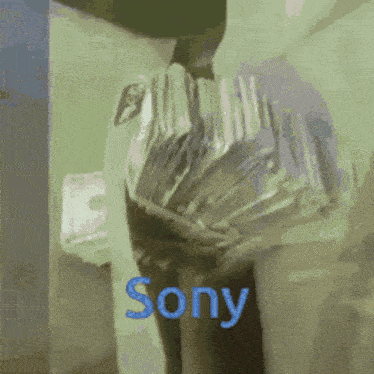 a person is holding a stack of money and the word sony is on the bottom right