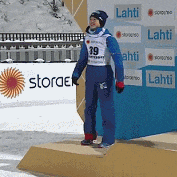 a person standing on a podium with a sign that says lahti on it