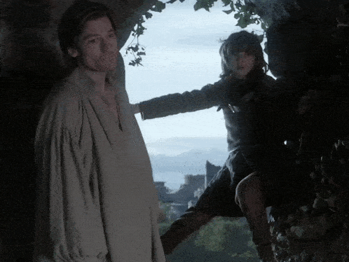 a man and a girl are standing next to each other in a cave