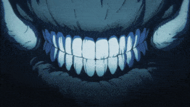 a close up of a monster 's teeth with horns in the background
