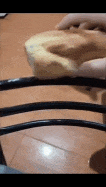 a person is using a sponge to clean a chair