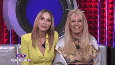 two women are sitting next to each other in front of a camera with the words grandefratello on the bottom right