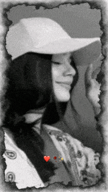 a black and white photo of a woman wearing a white hat with the word nike on it