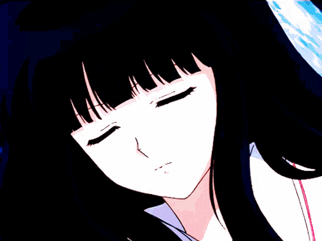 a close up of a girl 's face with a sad look on her face