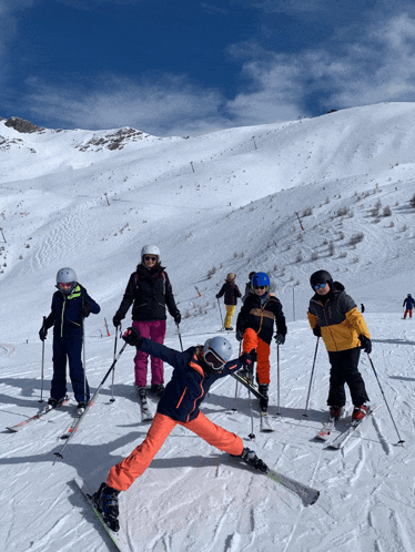 a group of children are skiing down a snowy mountain