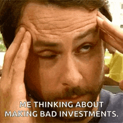 a man is holding his head while making a funny face .