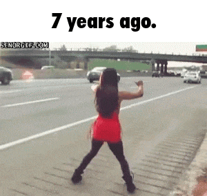 a woman in a red dress is dancing on the side of a highway with the words 7 years ago below her