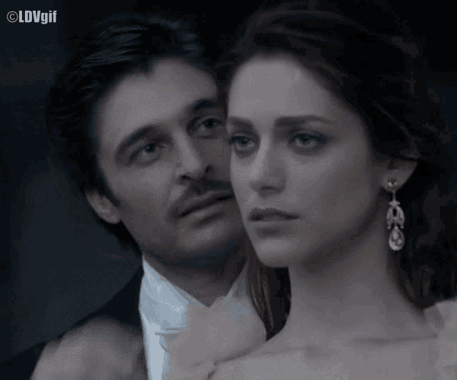 a man in a tuxedo and a woman in a dress are standing next to each other with a caption that says lovgil