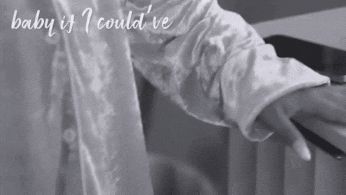 a black and white photo of a person holding hands with the words baby if i could ve written above them