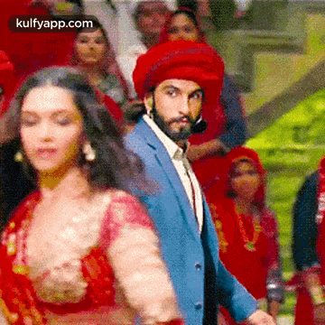 a man and a woman are dancing in front of a crowd .