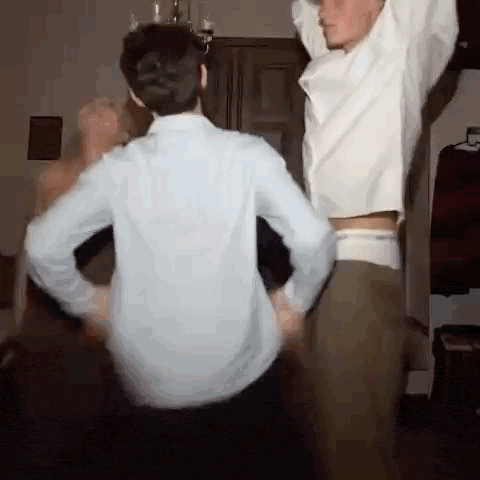 a couple of men are dancing together in a room .