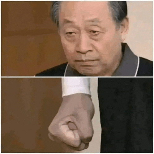 a man with a serious look on his face and a fist in his hand