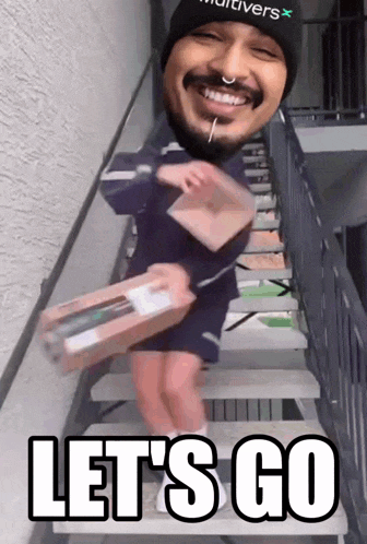 a man with a nose ring is walking down stairs with a box in his hand and the words let 's go below him