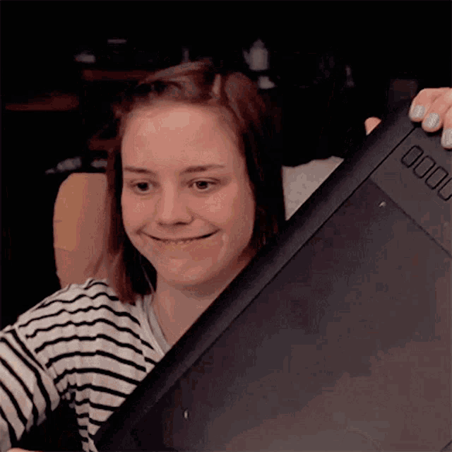 a woman is smiling while holding a tablet that says 0000