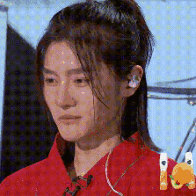 a close up of a woman wearing a red shirt