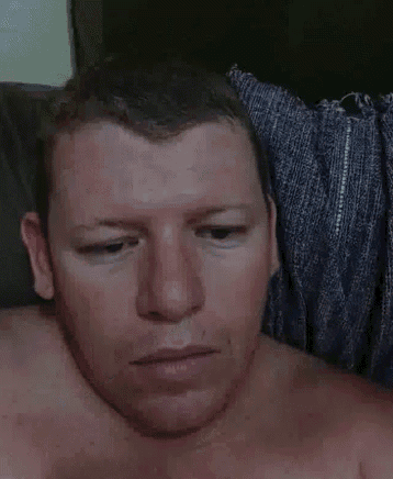 a man without a shirt is making a funny face
