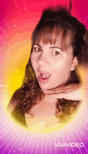 a woman with curly hair is making a funny face in a vivavideo video .